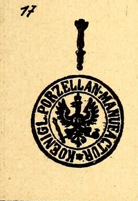 Über einem runden Stempel steht ein Zepter. Der Stempel zeigt in der Mitte einen gekrönten Adler, im Ring die Umschrift KOENIGL. PORZELLAN-MANUFACTUR. Graesse 1919 nennt keine Farbe. Chaffers 1886 beschreibt an anderer Stelle das Zepter blau unter der Glasur und den runden Stempel in Blau.
